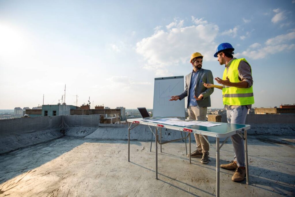 Team of architects and engineers people in group on construciton site check documents