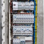 Voltage switchboard with circuit breakers are in the ON and OF positions in the big electric box for electrical distribution panel, and temporary electric cables are switched.