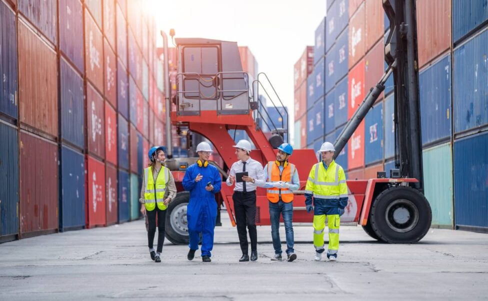 Manager and Cargo container worker having discussion on working plan together in the container yard,Logistics transportation and shipping business concepts Logistics Solutions