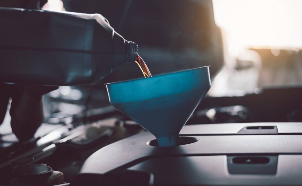 Mechanic lubricant oil motor level for refueling and pouring oil quality into the engine motor car Transmission and Maintenance.